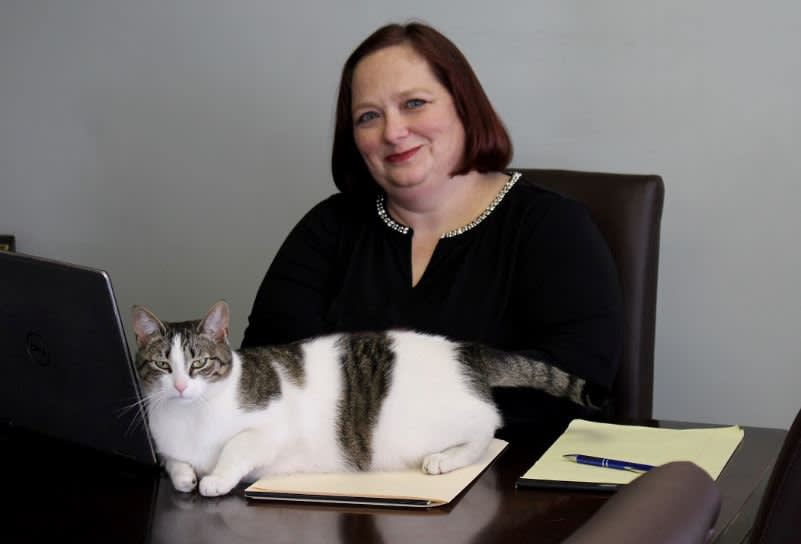 Attorney at Law Laurinda J. Voelcker sitting at desk